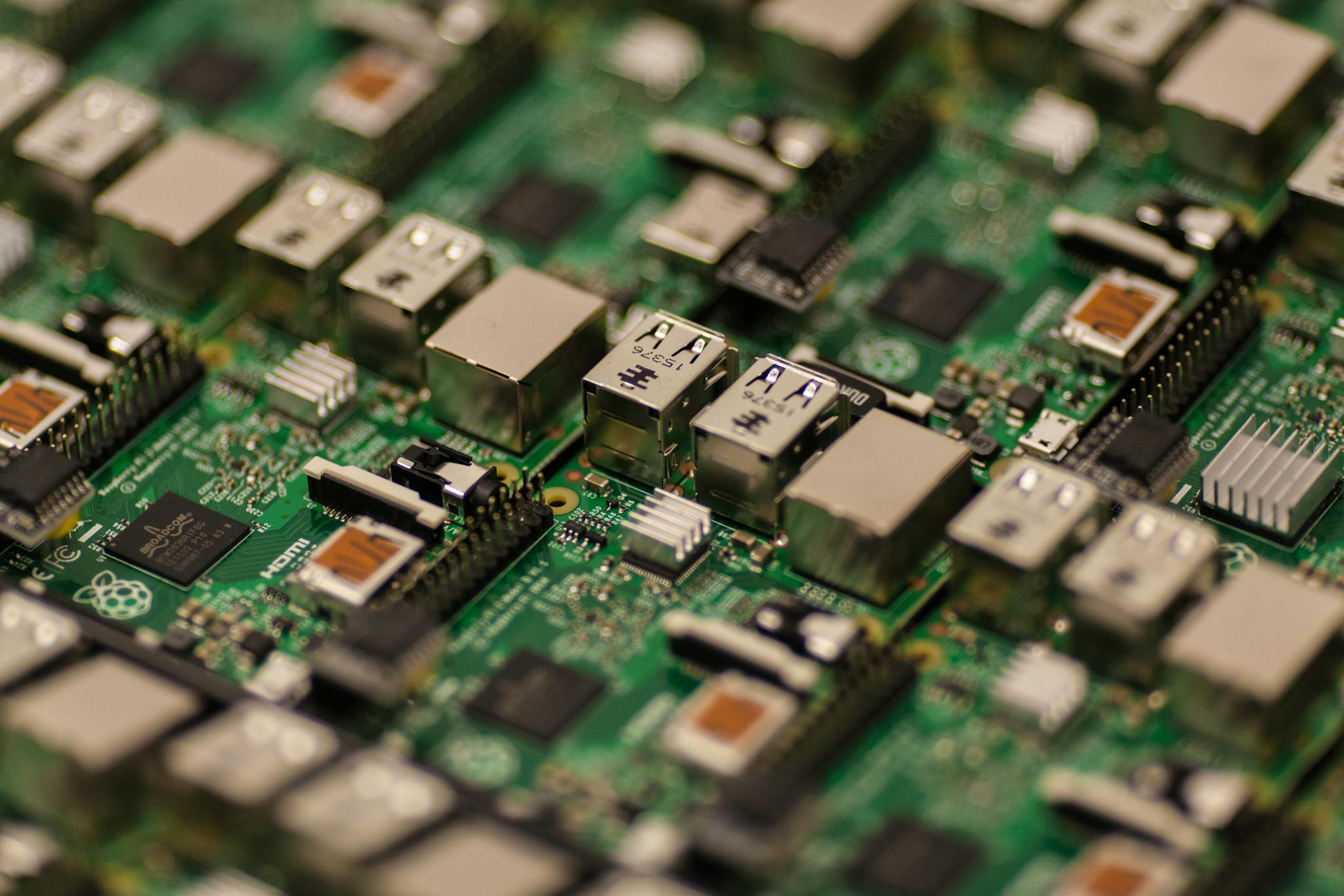 end of support Detailed shot of a Raspberry Pi circuit board showcasing its components, USB ports, and microchips.
